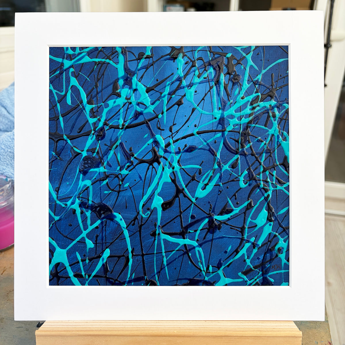 Original abstract painting Current II by Mike Hall, featuring turquoise and blue expressive marks, presented in a buff mount.