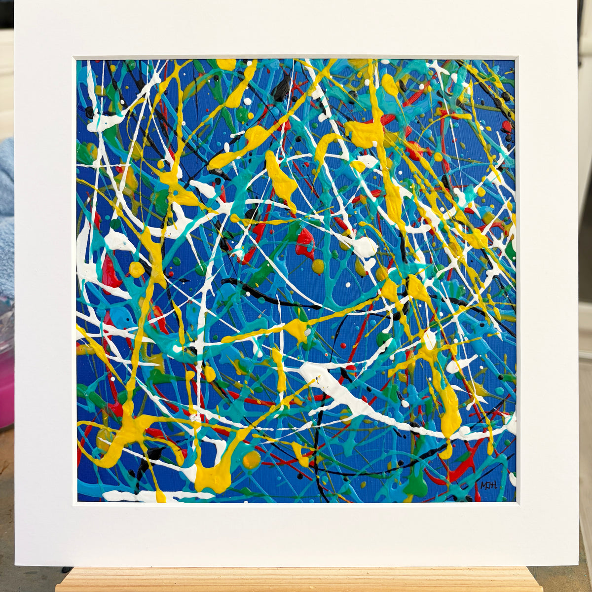 Original abstract painting Electric I by Mike Hall, featuring vibrant blue, yellow and white, presented in a buff mount.