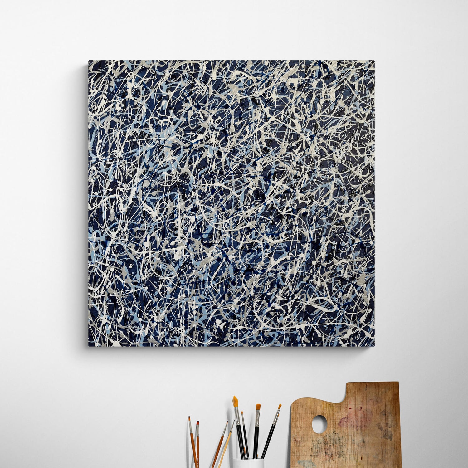 Vibrant abstract artwork displayed in a modern office, energising the workspace. Using white, silver and light blue acrylic over a dark blue background.