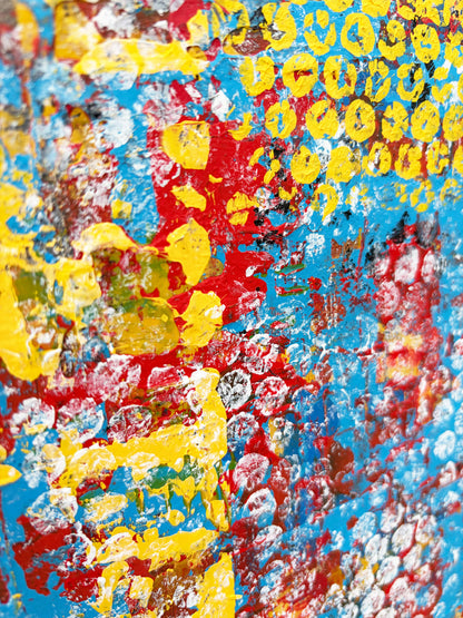 Close-up of expressive abstract painting featuring bright red, yellow and turquoise blue with overlapping circular marks and rich textures.