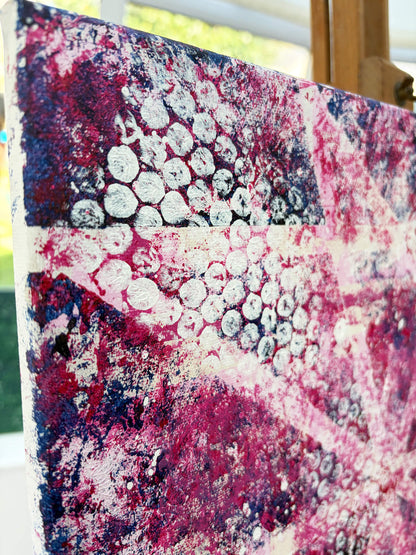 Detailed angled view of Pop & Circumstance II showing white circular patterns over deep pink, magenta and dark blue textured layers.
