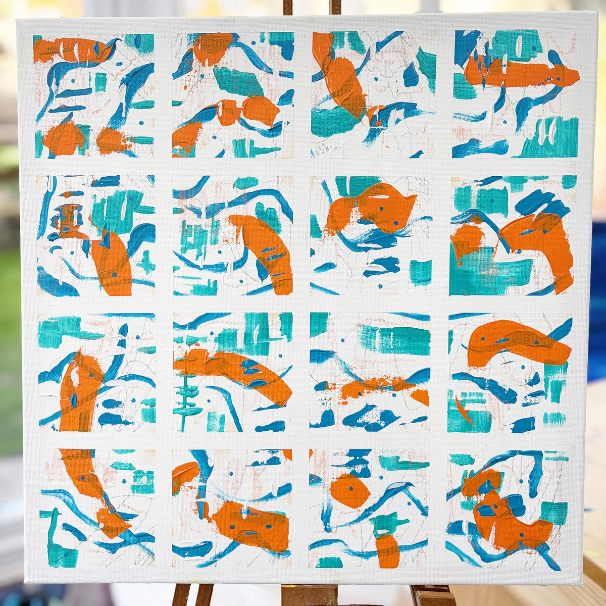 Squared-Up original abstract painting by Mike Hall, featuring 16 individual squares with expressive orange, turquoise and blue brushstrokes on a white canvas.