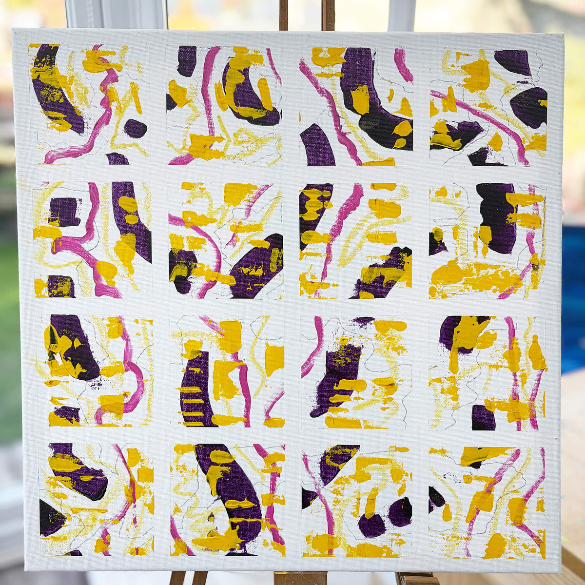 Squared-Up original abstract painting by Mike Hall, featuring 16 individual squares with expressive yellow, deep purple and pink brushstrokes on a white canvas.