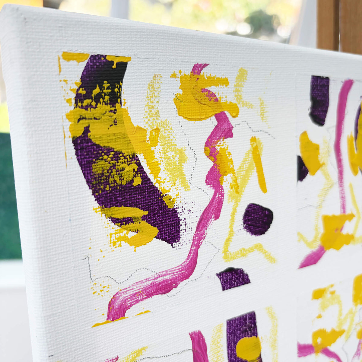 Angled view of Squared-Up original canvas artwork by Mike Hall, showing the colourful 16-square composition and textured painted surface.