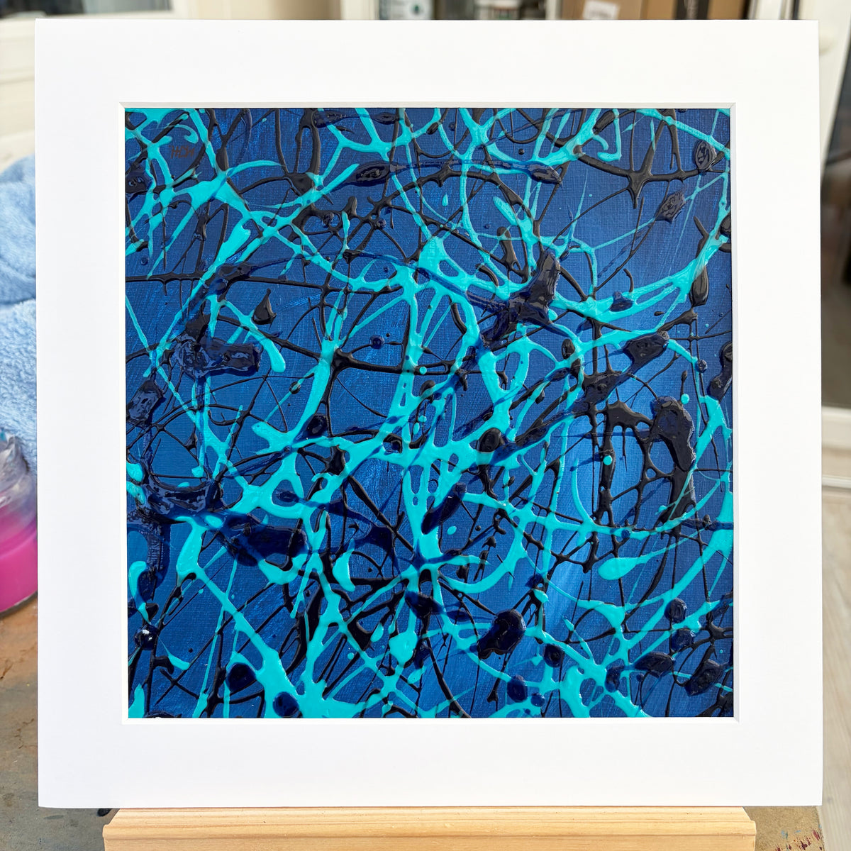Original turquoise and blue abstract painting Current I by Mike Hall of MJH ArtStudio, displayed in a buff mount