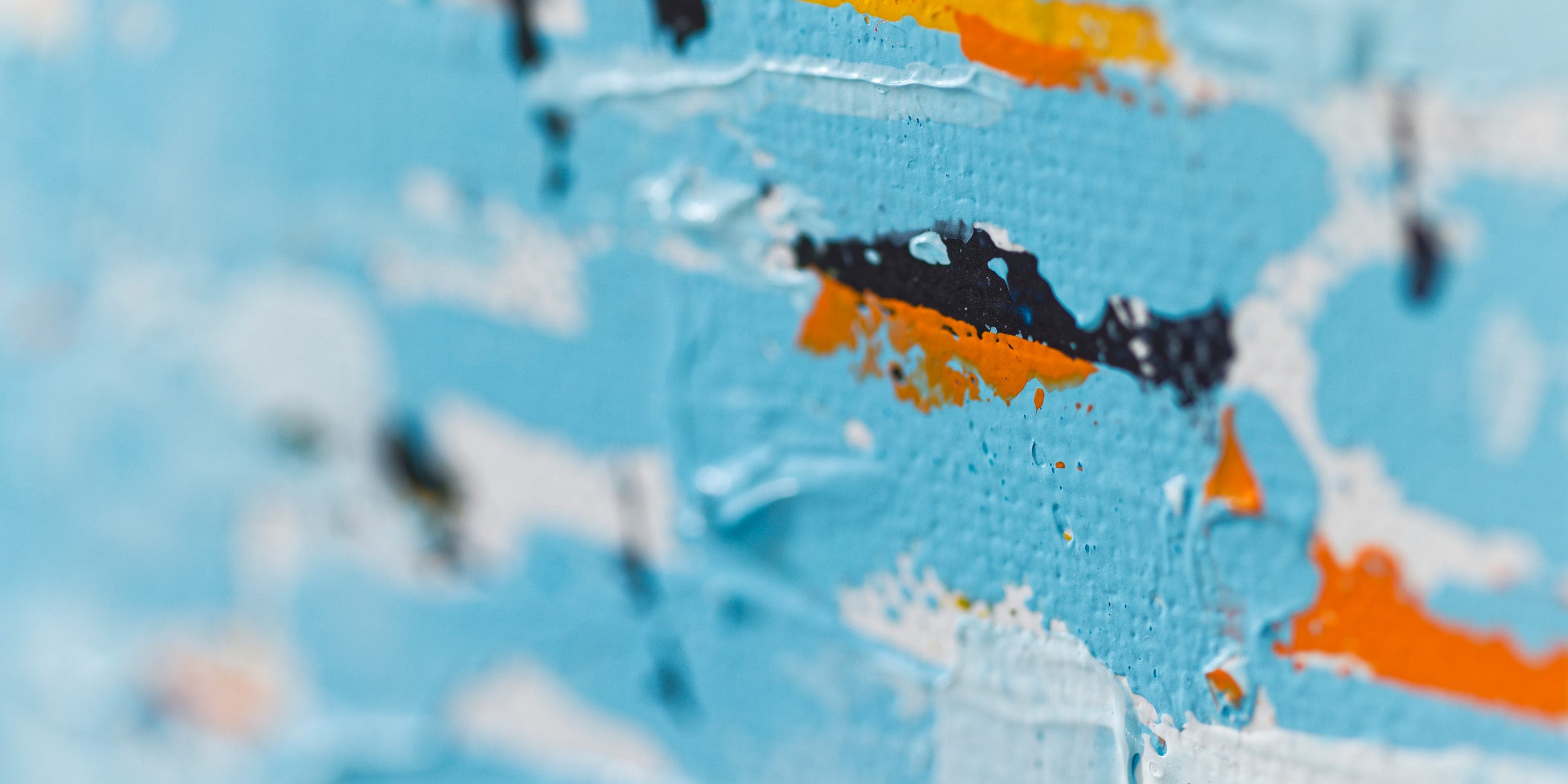 Close-up of an abstract painting showing layered colour and texture